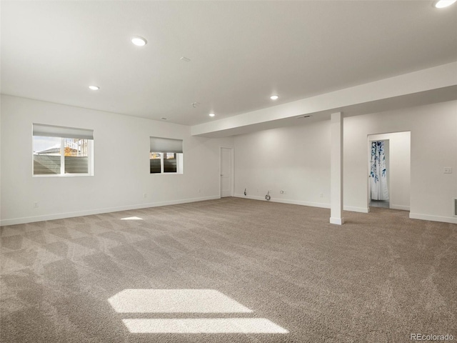 below grade area featuring recessed lighting, light carpet, and baseboards