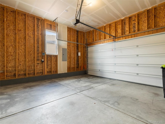 garage featuring electric panel and a garage door opener