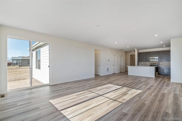 unfurnished living room featuring light wood-type flooring