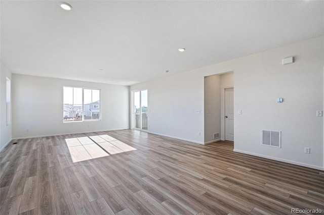 spare room with hardwood / wood-style flooring