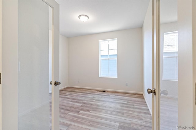 spare room featuring light hardwood / wood-style floors