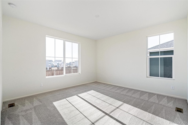 carpeted empty room featuring a healthy amount of sunlight