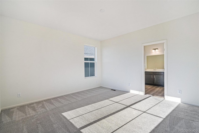 carpeted empty room featuring sink