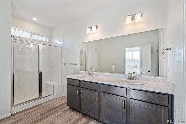 bathroom featuring hardwood / wood-style floors, a healthy amount of sunlight, and walk in shower