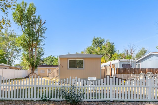 view of front of house featuring a storage unit