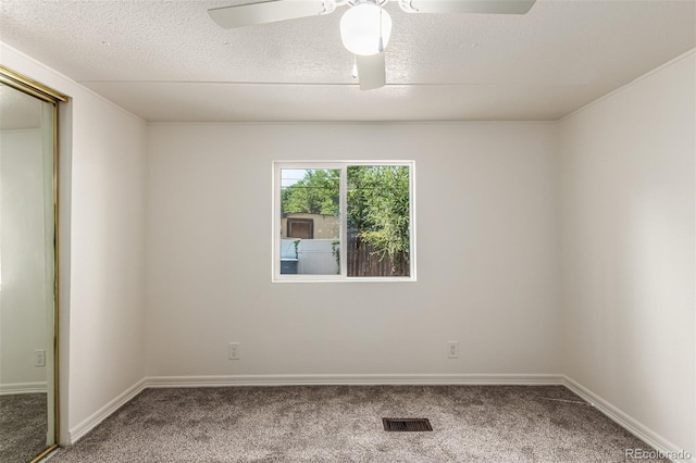 unfurnished room featuring carpet, ceiling fan, and a textured ceiling