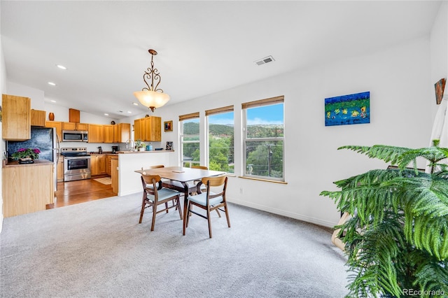 10 Taos Pl, Manitou Springs, CO 80829 - dining space featuring light carpet, vaulted ceiling, and recessed lighting