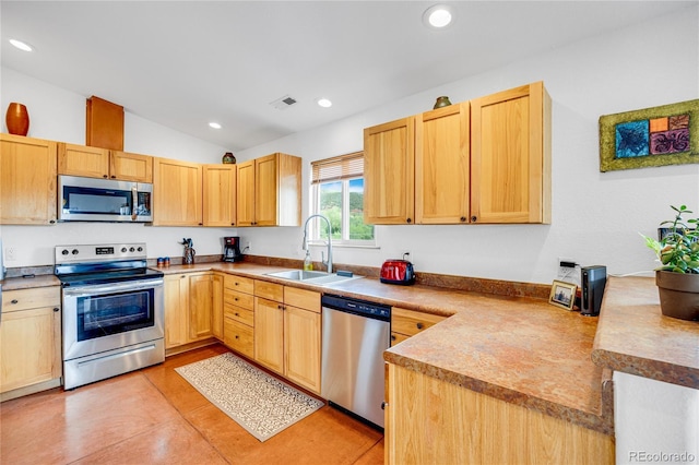 10 Taos Pl, Manitou Springs, CO 80829 - kitchen with appliances with stainless steel finishes, recessed lighting, light brown cabinetry, and lofted ceiling