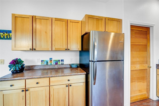 10 Taos Pl, Manitou Springs, CO 80829 - kitchen with freestanding refrigerator, dark countertops, and light brown cabinets