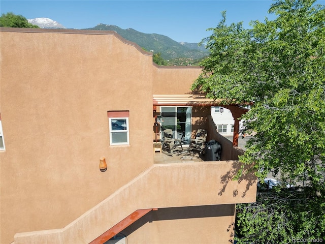 10 Taos Pl, Manitou Springs, CO 80829 - back of house with stucco siding, a mountain view, and a patio area