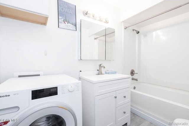 62927 US Highway 40 Unit 127, Granby, CO 80446 - full bath with washer / dryer, vanity, shower / bathtub combination with curtain, and wood finished floors
