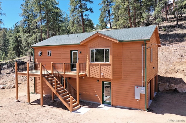 325 Bob Cat Trl, Bailey, CO 80421 - back of house with stairs, a deck, a garage, and a shingled roof