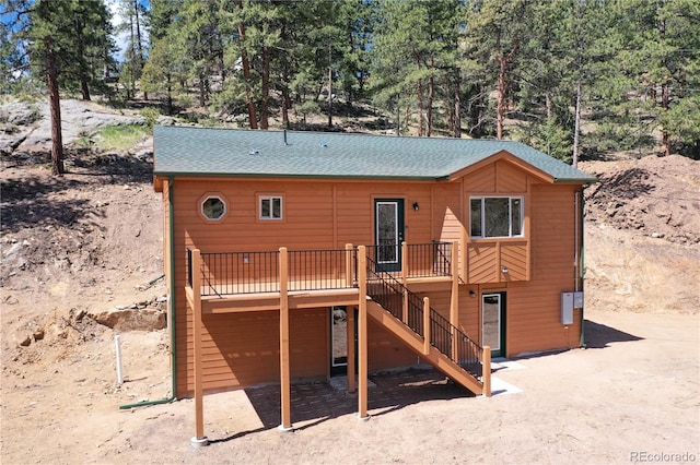 325 Bob Cat Trl, Bailey, CO 80421 - back of house featuring a wooden deck, stairs, and roof with shingles