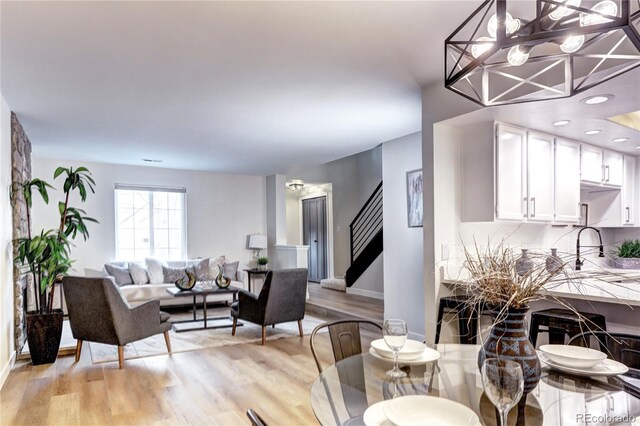 dining room featuring sink and light hardwood / wood-style floors