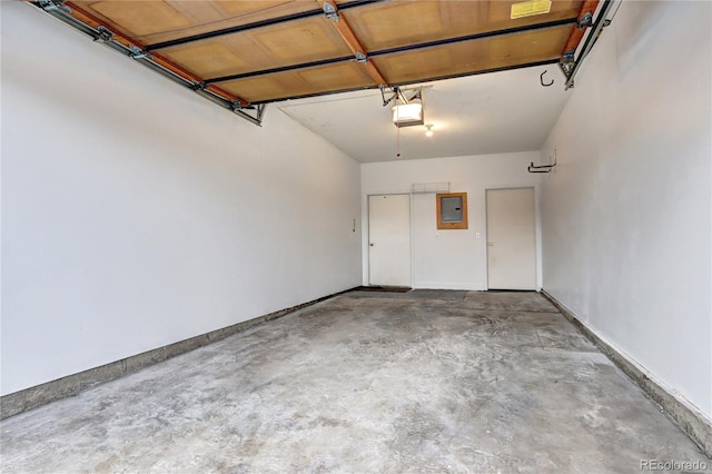 garage with a garage door opener and electric panel