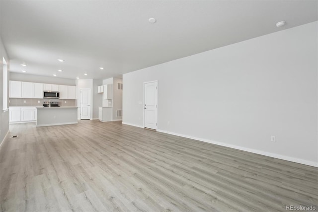 unfurnished living room featuring light wood-type flooring