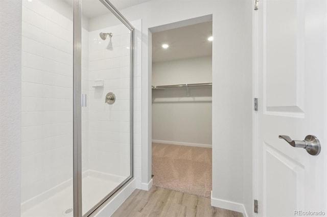 bathroom featuring hardwood / wood-style floors and walk in shower