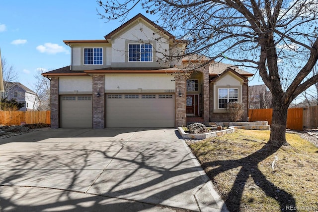 view of front of property with stucco siding, fence, and brick siding