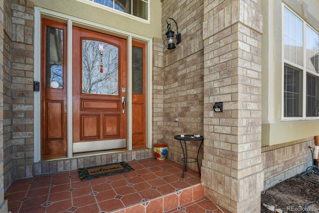 entrance to property featuring brick siding