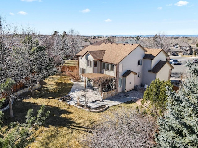 rear view of property with central AC, a shingled roof, a patio area, and fence