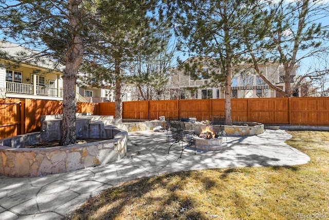 view of yard featuring a fire pit, a patio, and fence