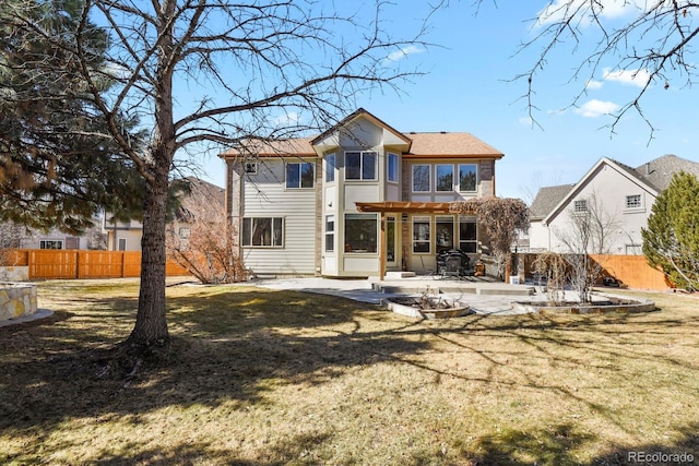 rear view of house with a patio area, fence, and a lawn