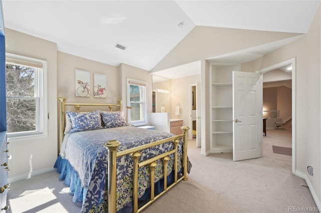 bedroom featuring connected bathroom, light colored carpet, baseboards, vaulted ceiling, and visible vents