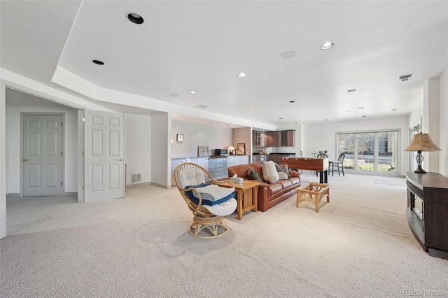 living area with recessed lighting, light colored carpet, and visible vents