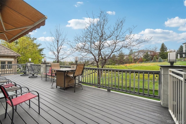 wooden terrace featuring outdoor dining space