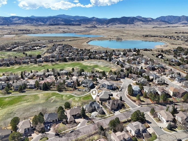 birds eye view of property featuring a water and mountain view, view of golf course, and a residential view