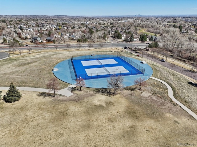 view of pool with fence and a tennis court