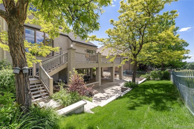 7081 Salvia St, Arvada, CO 80007 - back of property with stairway, stucco siding, a fenced backyard, and a deck