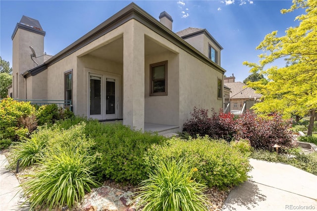 7081 Salvia St, Arvada, CO 80007 - view of side of property featuring a chimney and stucco siding