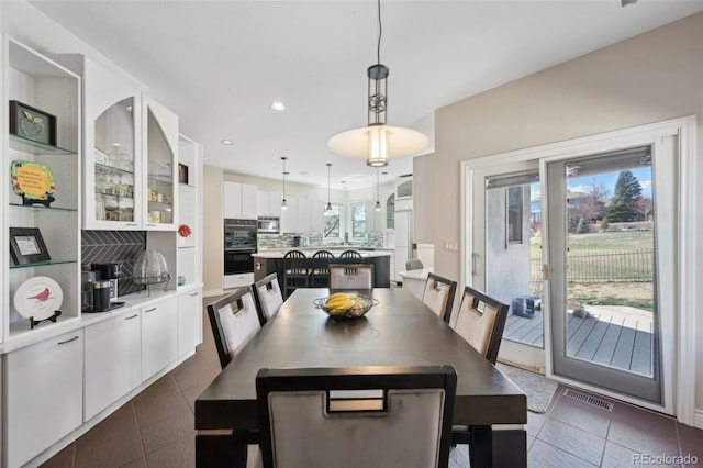 7081 Salvia St, Arvada, CO 80007 - dining room featuring recessed lighting and dark tile patterned floors