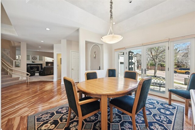 7081 Salvia St, Arvada, CO 80007 - dining space with plenty of natural light, wood finished floors, recessed lighting, and stairs