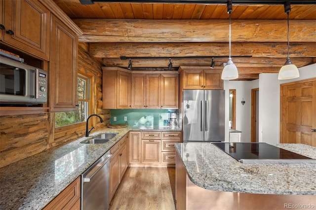 80 Spruce Ct, Evergreen, CO 80439 - kitchen featuring stainless steel appliances, log walls, light wood-style floors, pendant lighting, and light stone countertops