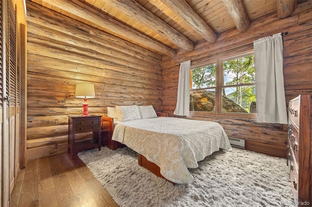 80 Spruce Ct, Evergreen, CO 80439 - bedroom with a wooden ceiling with exposed beams, wood finished floors, log walls, and baseboard heating
