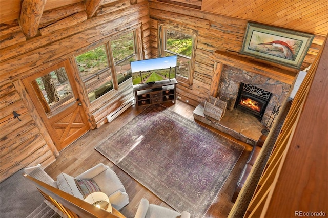 80 Spruce Ct, Evergreen, CO 80439 - living room featuring a fireplace, wood finished floors, wooden ceiling, and wooden walls