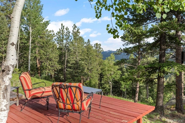 80 Spruce Ct, Evergreen, CO 80439 - deck featuring a view of trees and a mountain view
