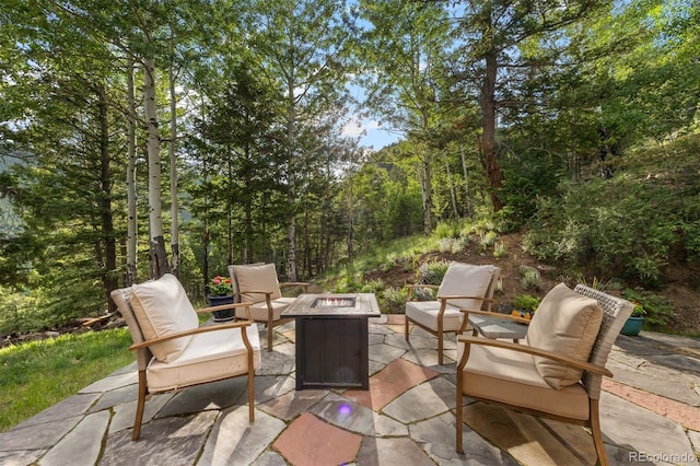 80 Spruce Ct, Evergreen, CO 80439 - view of patio featuring a fire pit and a view of trees
