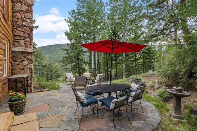 80 Spruce Ct, Evergreen, CO 80439 - view of patio with outdoor dining space and a mountain view