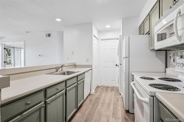 4899 S Dudley St Unit 7E, Littleton, CO 80123 - kitchen with white appliances, light wood finished floors, light countertops, green cabinets, and recessed lighting