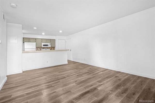 4899 S Dudley St Unit 7E, Littleton, CO 80123 - unfurnished living room with recessed lighting and wood finished floors