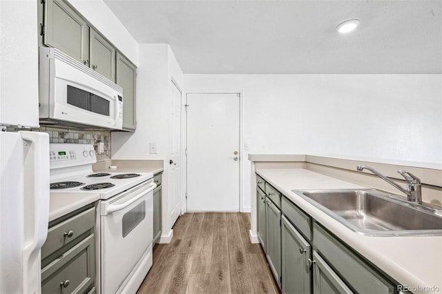 4899 S Dudley St Unit 7E, Littleton, CO 80123 - kitchen featuring white appliances, light wood-style floors, gray cabinetry, light countertops, and decorative backsplash