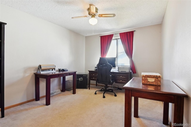 office area featuring light colored carpet, a textured ceiling, and ceiling fan
