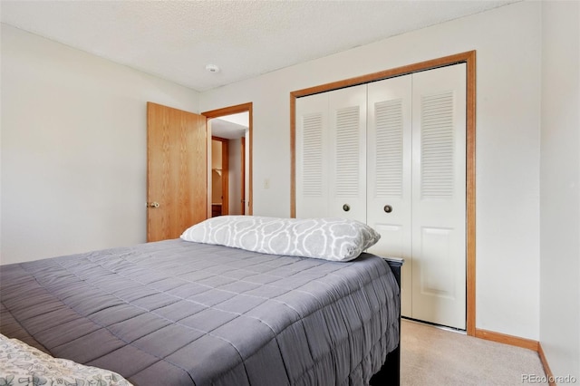 bedroom featuring light carpet, a closet, and baseboards