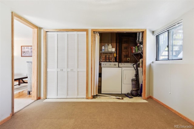 washroom featuring washing machine and clothes dryer, laundry area, carpet, and baseboards