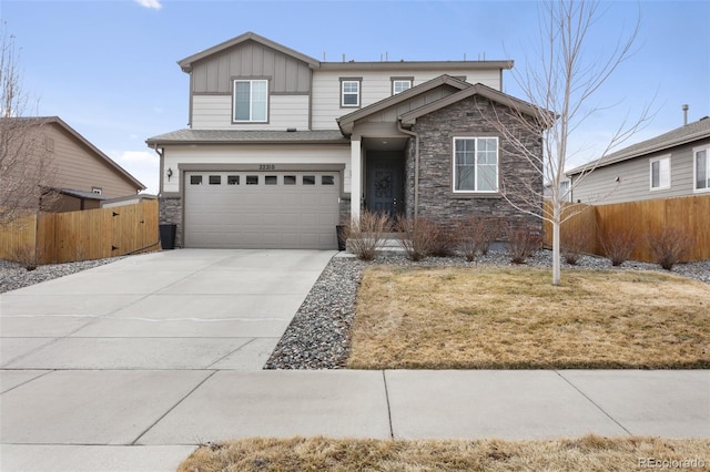 view of front of home featuring driveway, stone siding, fence, and board and batten siding