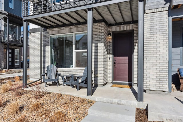 view of exterior entry with a patio