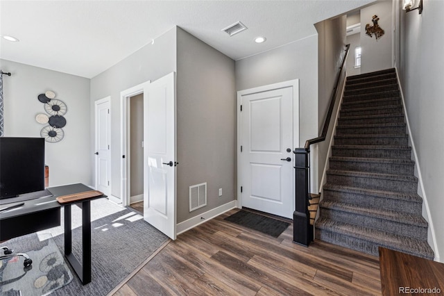 entryway with dark wood-type flooring